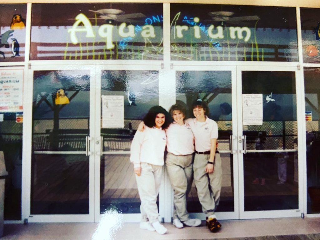 An old picture of 3 women in front of the old Jenkinson's Aquarium sign.