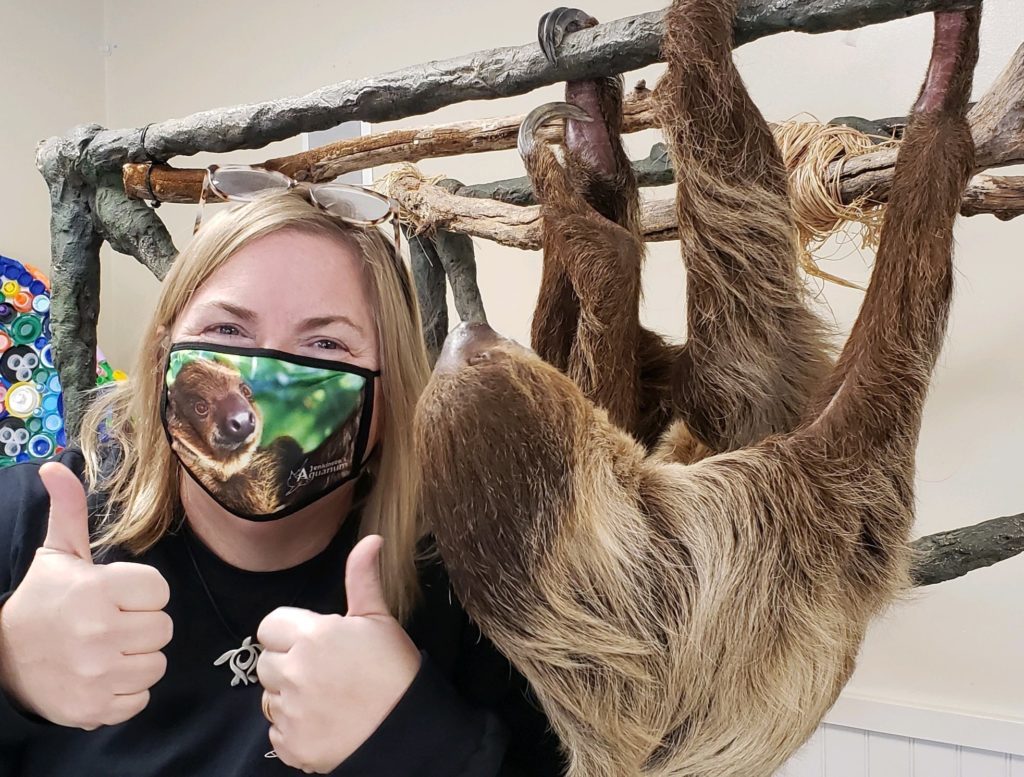 Jenkinson's employee giving 2 thumbs up next to Wally the Sloth.