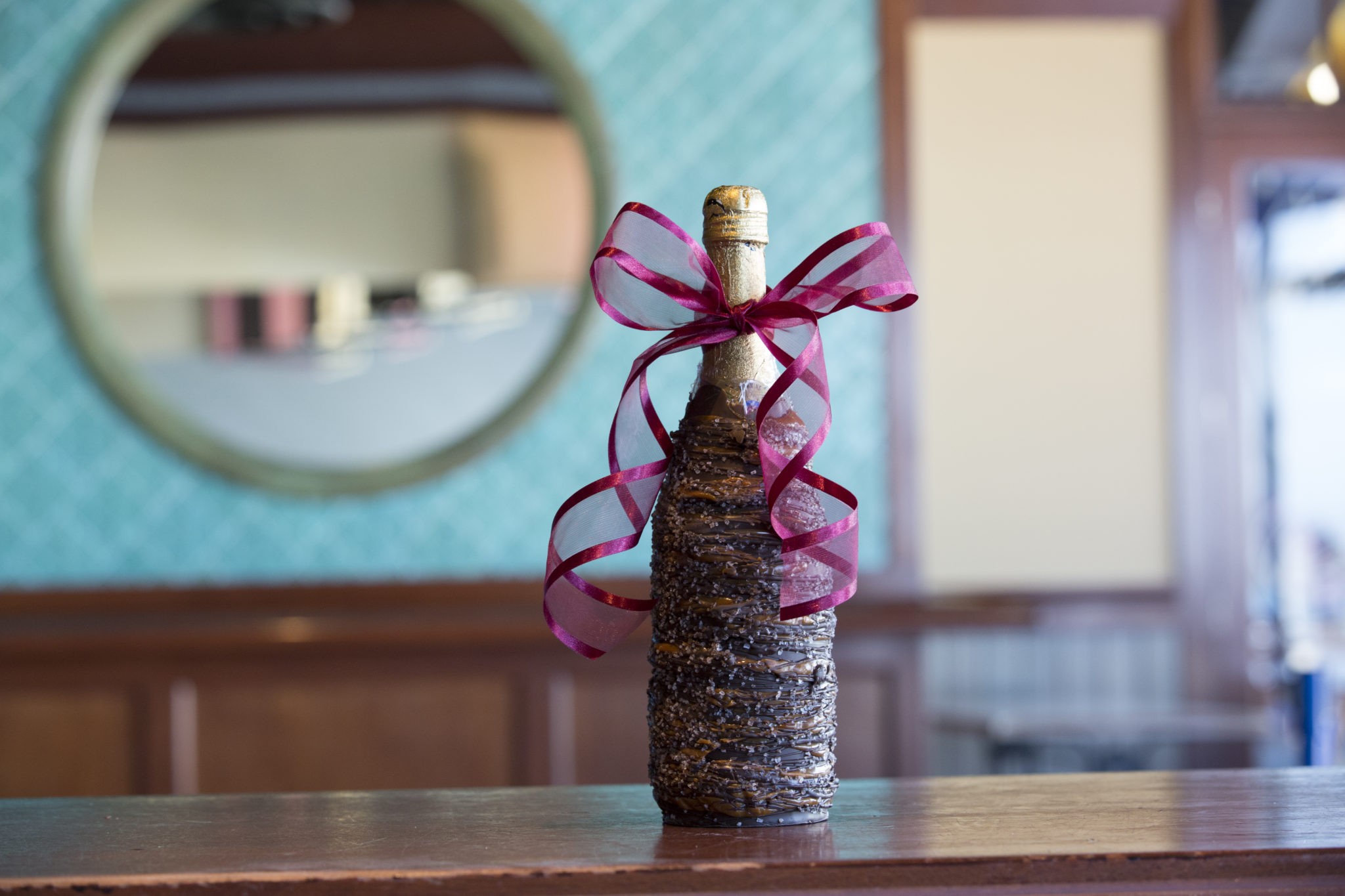 A dark chocolate dipped wine bottle.