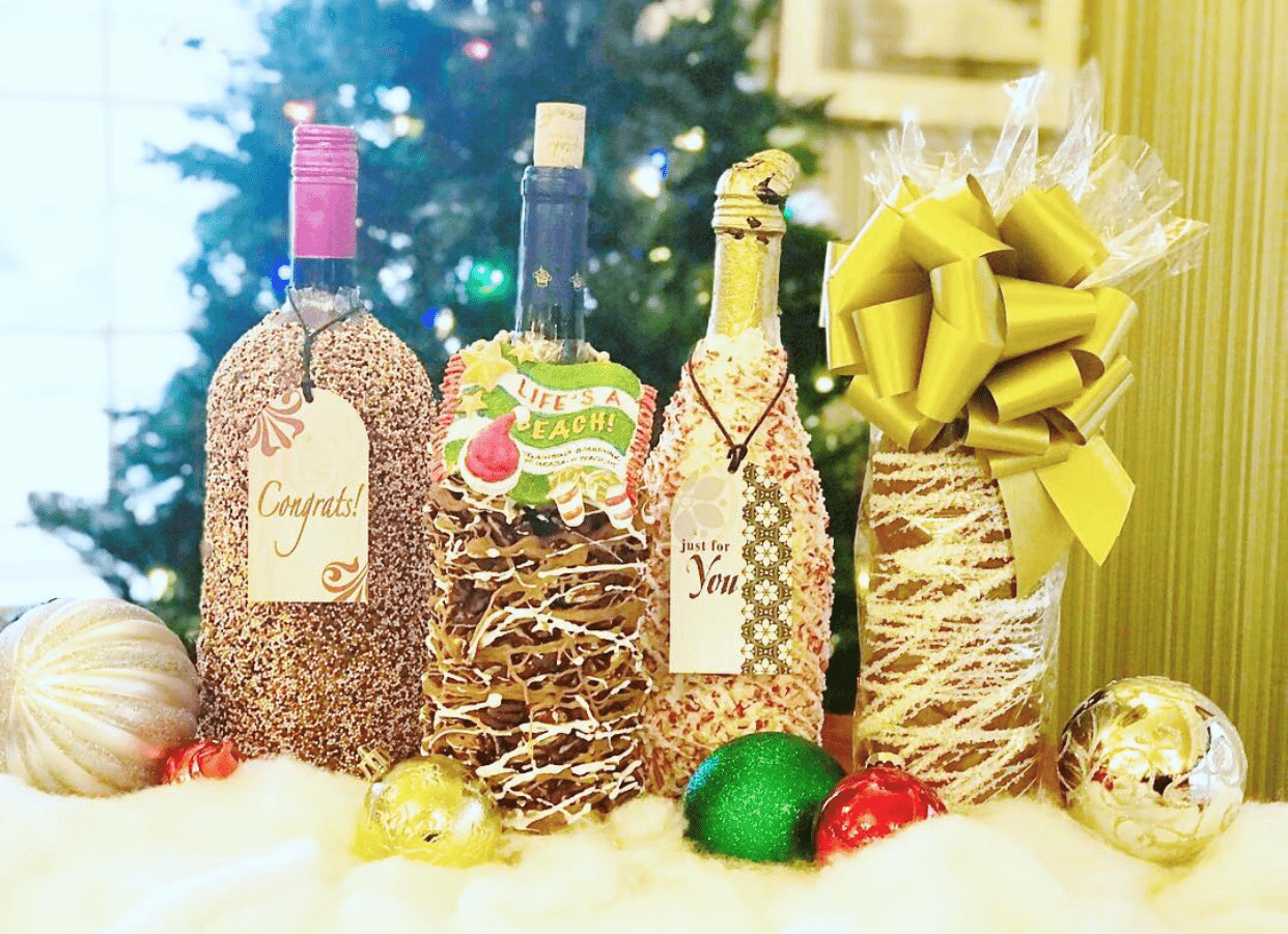 A display of chocolate dipped wine bottles decorated for Christmas inside Jenkinson's Sweet Shop.