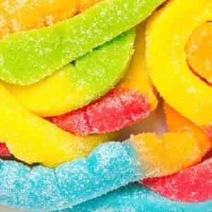 Close up of multicolored sour gummy worms.