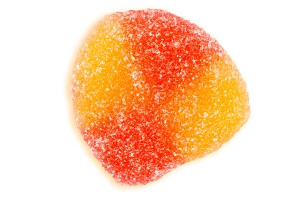 A single red and orange sour fuzzy peach gummy.