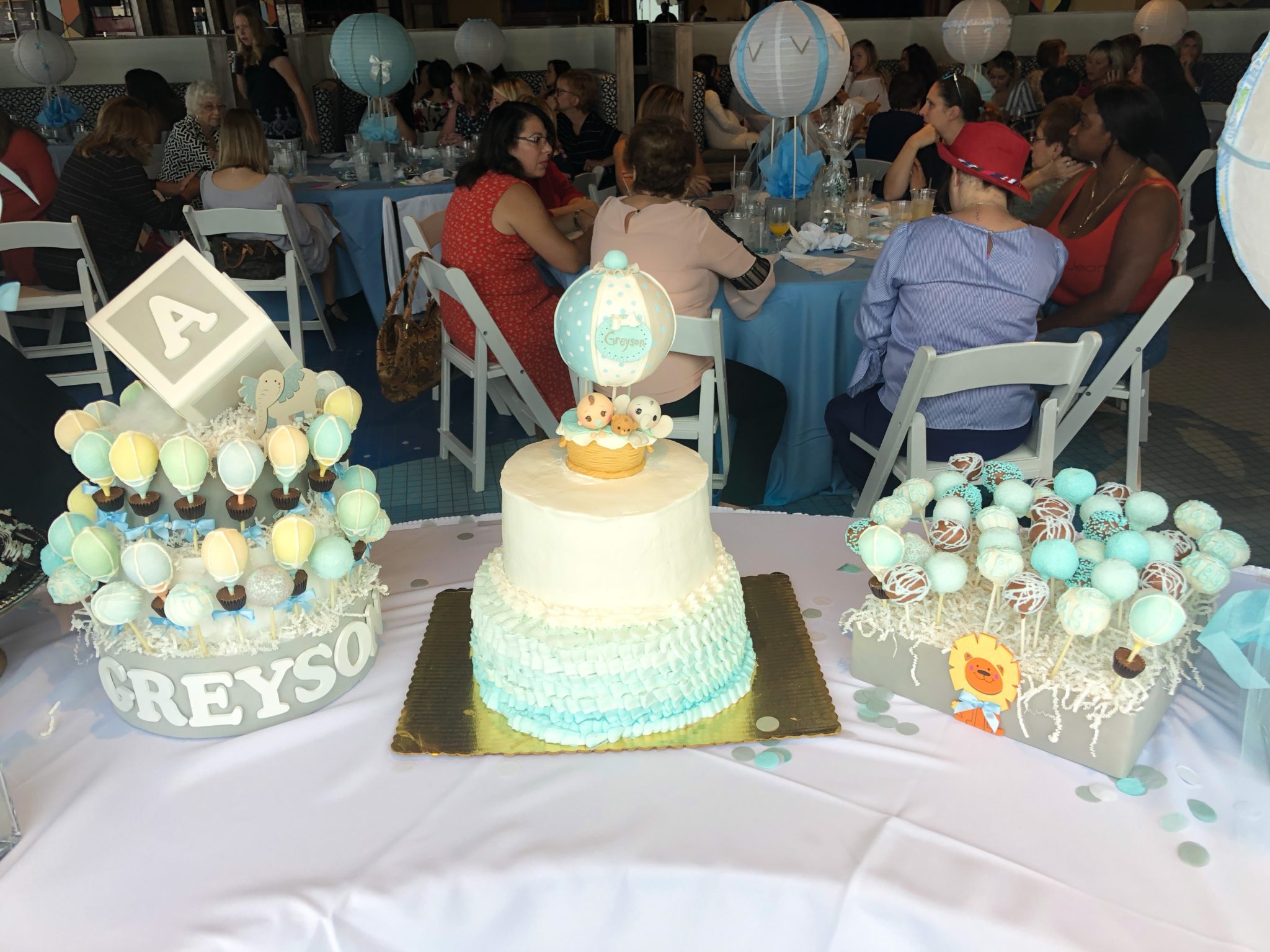 A dessert table featuring custom baby shower cake pops.
