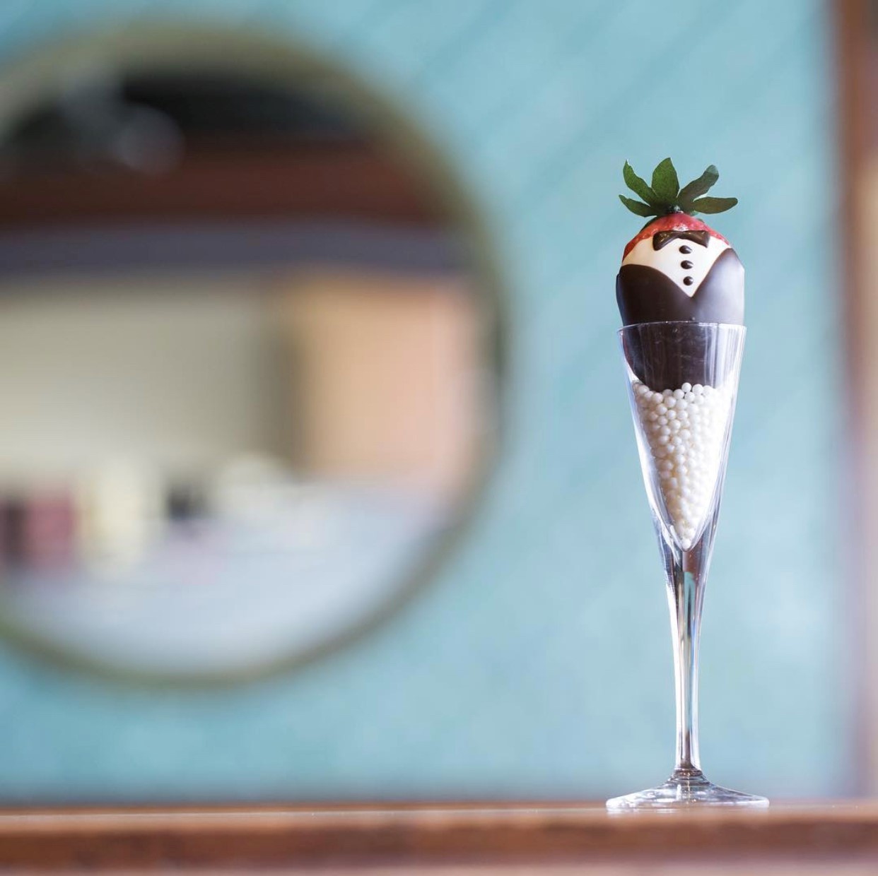 A chocolate covered strawberry sitting in a champagne flute from Jenkinson's Sweet Shop.