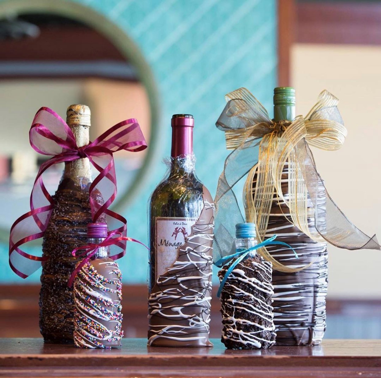 An assortment of chocolate dipped wine bottles.