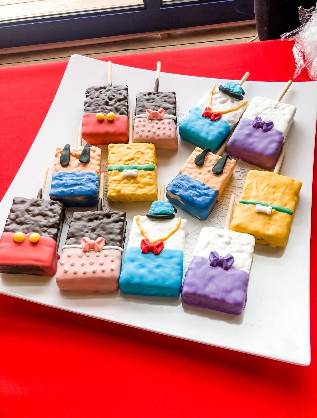 Chocolate covered rice krispy pops decorated like the characters from Mickey Mouse Clubhouse.