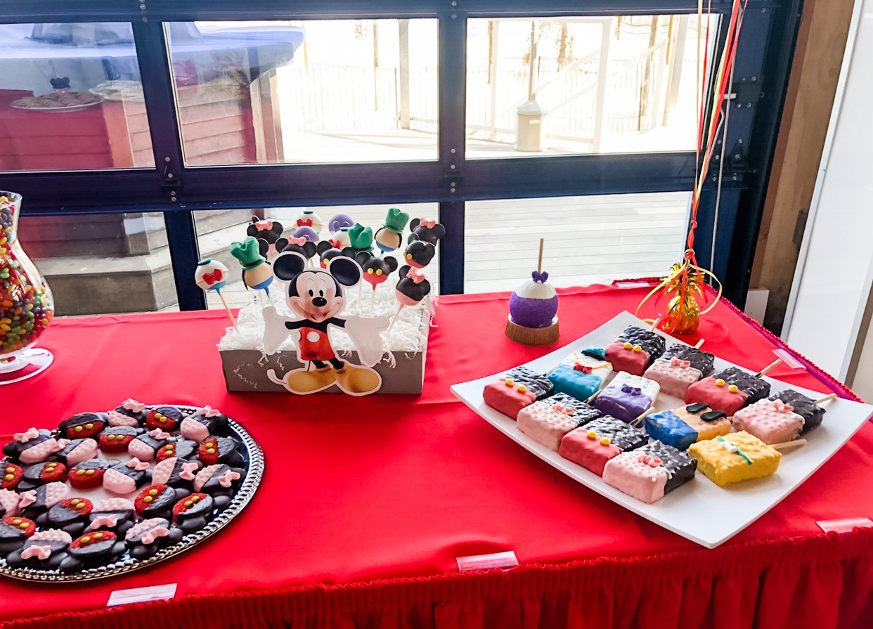 A custom dessert table featuring Mickey Clubhouse assorted chocolate dipped treats.