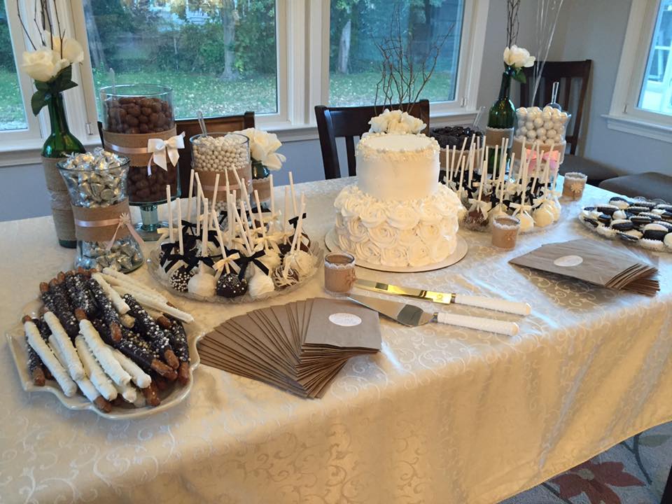 Custom wedding candy buffet featuring a cake, cake pops, Oreos and pretzel rods.