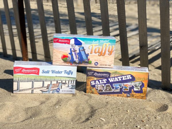 An assortment of salt water taffy souvenir boxes displayed on the beach at Jenkinson's.
