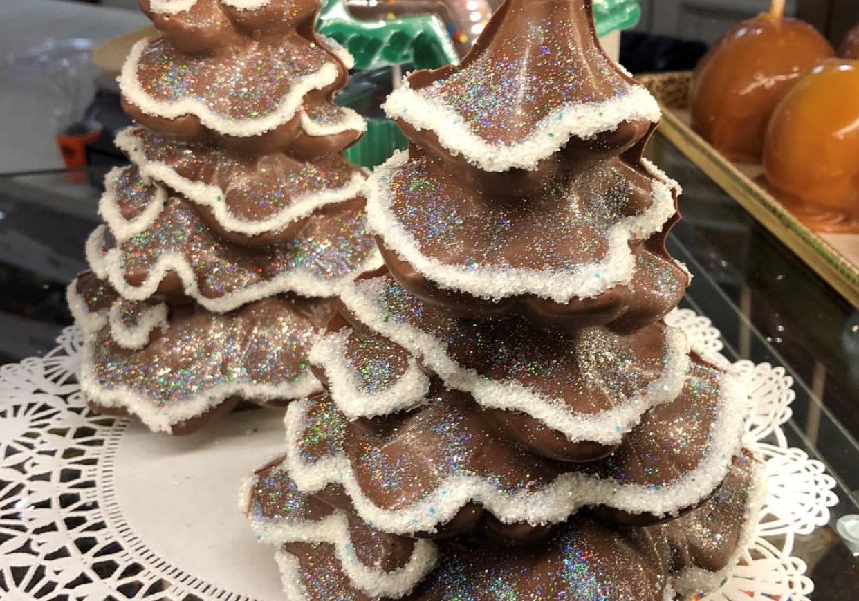 A display of hollow chocolate Christmas trees decorated with candy "snow".