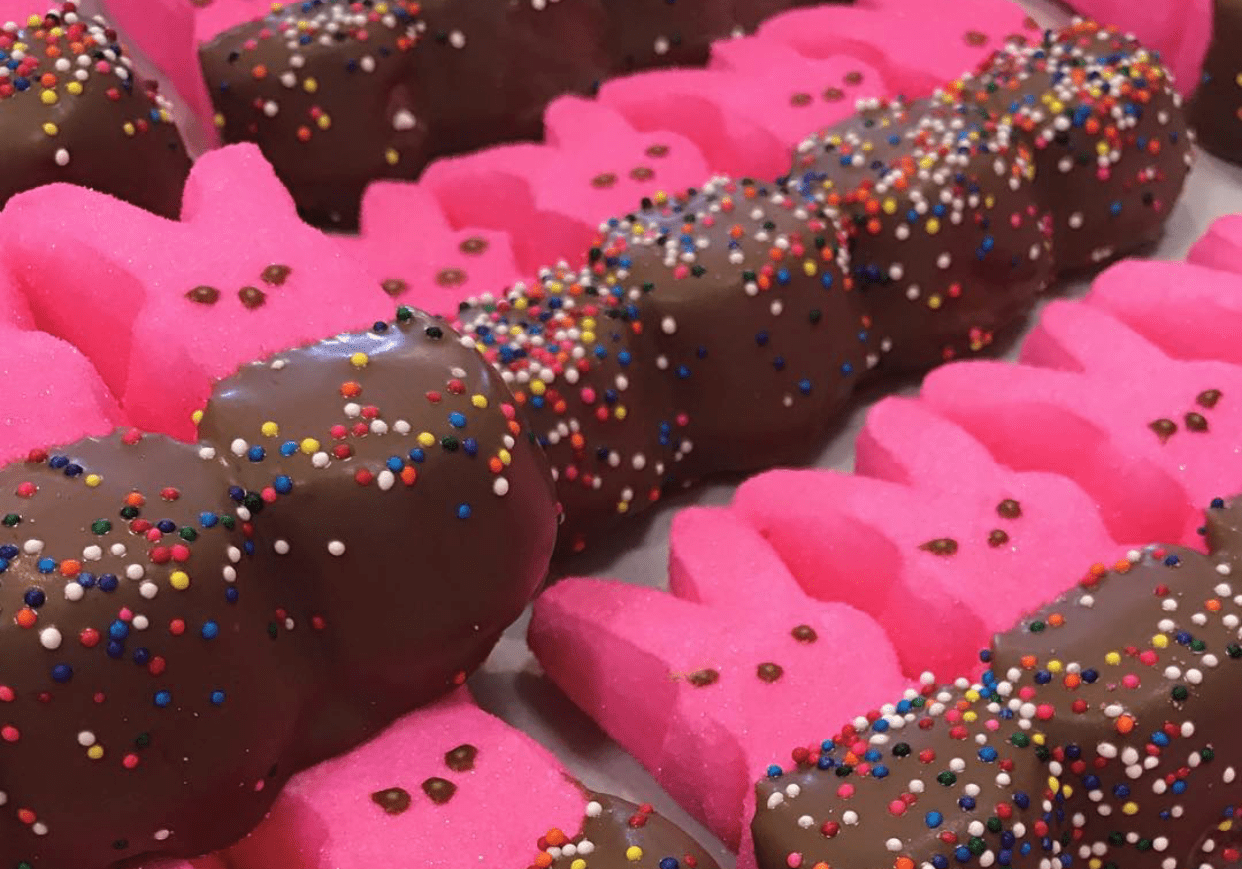 A bunch of chocolate dipped pink peeps.