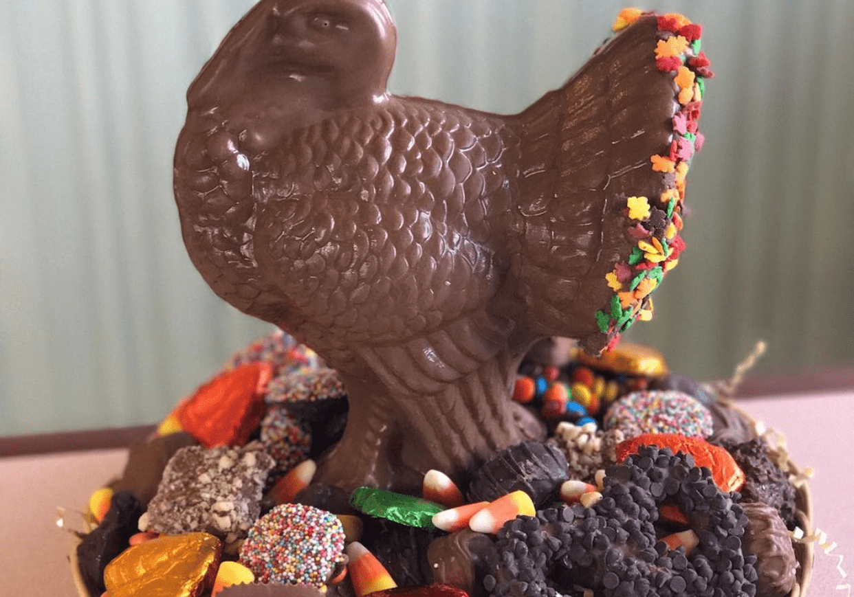 A Thanksgiving assorted chocolate platter featuring a large chocolate turkey in the center.