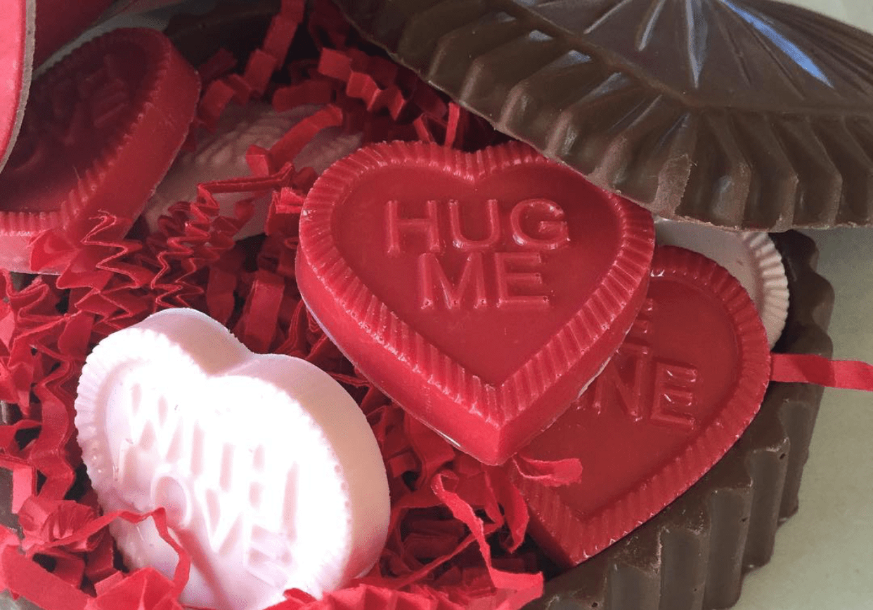 A edible chocolate heart shaped Valentine's box filled with chocolate heart shaped candy.