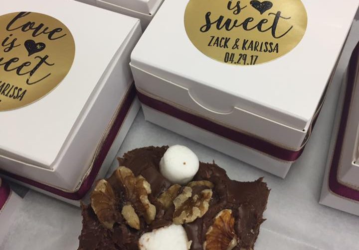 A piece of Rocky Road fudge sitting next to a custom favor box.