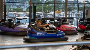 A child driving in a blue Bumper Car at the Jenkinson's Amusement Park