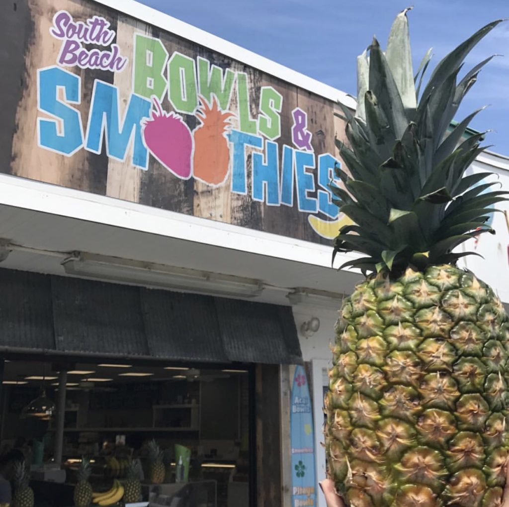 A photo of a pineapple in front of Jenkinson's South Beach Sweets, Bowls and Smoothies.