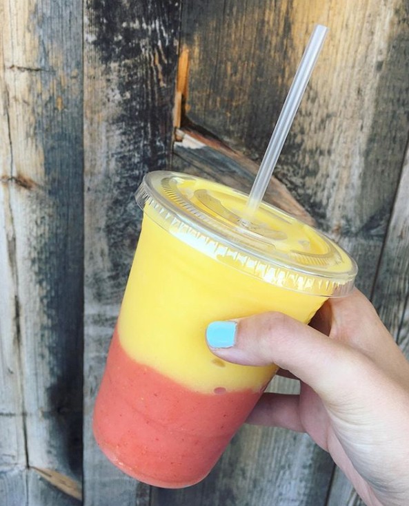 A half pink, half orange smoothie from South Beach Sweets, Bowls & Smoothies.