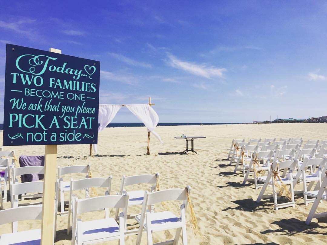 Chairs set up on the beach for a wedding ceremony.