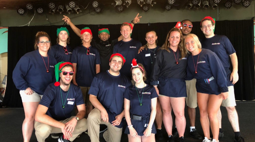 A group picture of about 13 employees at Jenkinson's Boardwalk wearing Christmas accessories.