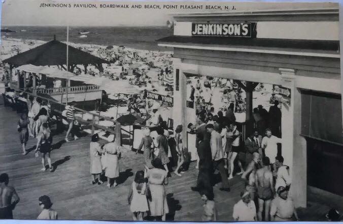 The history of Jenkinson's Boardwalk! Jenkinson's Pavillion Boardwalk and beach crowded with people, Point Pleasant Beach, NJ.