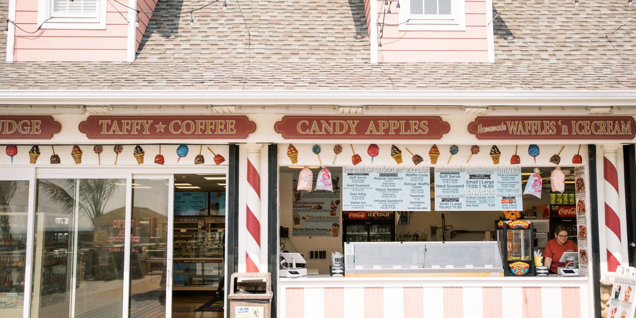 Candy store facade with a festive candy cane decoration.