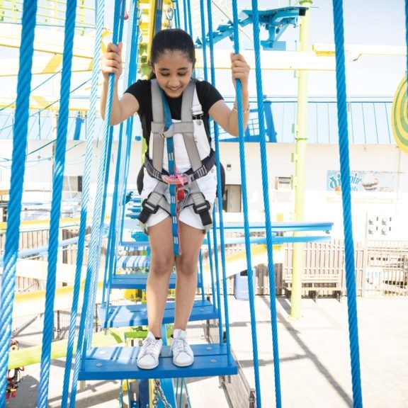 A female visitor enjoys Adventure Lookout Ropes Course at Jenkinson's Boardwalk