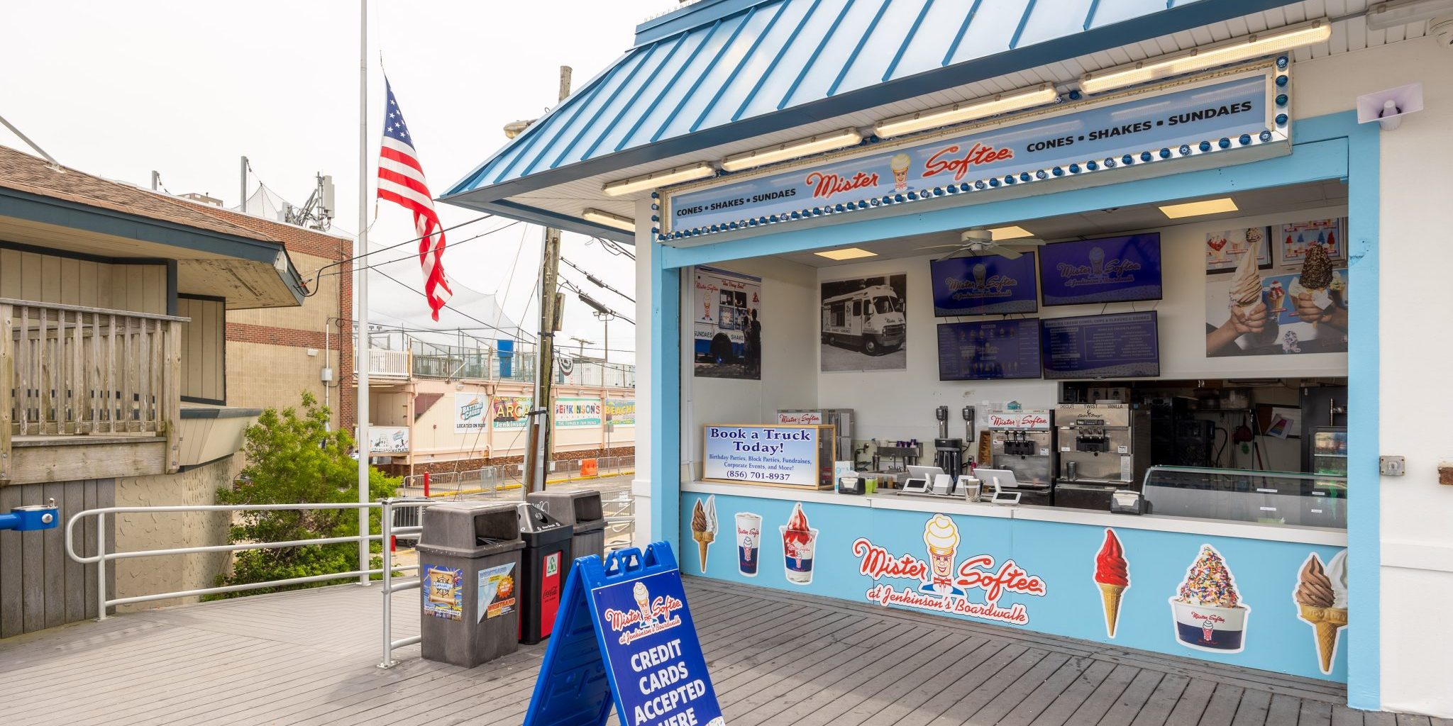 The front of Mister Softee at Jenkinson's Boardwalk in Point Pleasant Beach New Jersey with digital signs and images of ice cream cones and shakes