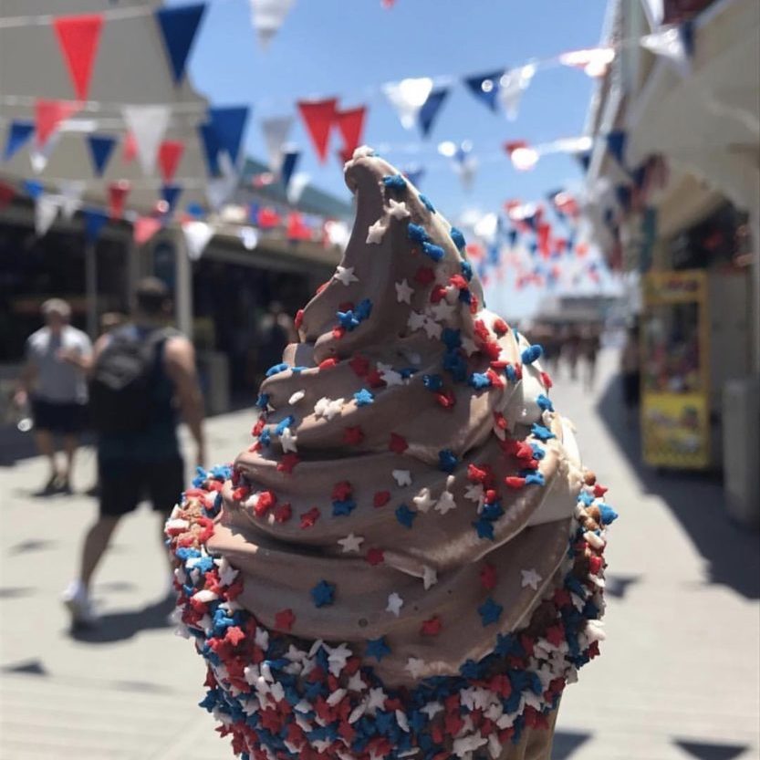 A chocolate ice cream cone with red, white and blue sprinkles for 4th of July.
