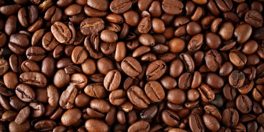 A close up picture of a bunch of brown coffee beans. 