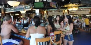 A picture of people enjoying food and drinks from the raw bar at Jenkinson's Pavilion.
