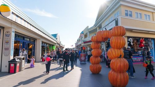 Families walking through pumpkin arch on Jenkinson’s Boardwalk