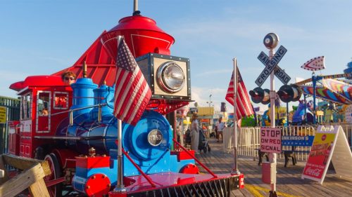 Red and blue train ride on Jenkinson’s Boardwalk with American flags